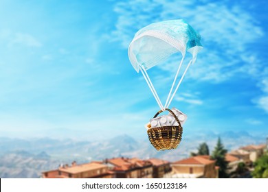 Medical Mask In The Form Of A Parachute And A Basket With Pills On A Sky Background. Humanitarian Aid Concept