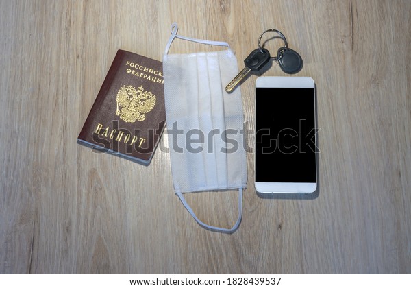 medical mask and keys, medical mask and\
phone on the table, white medical mask and\
passport