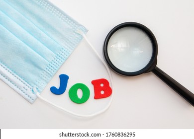 Medical Mask And A Magnifying Glass Near The Word Job Done With Letters, Top View. Job Search During Coronavirus Concept