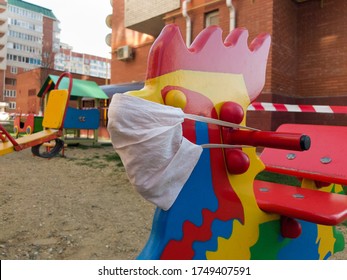 Medical Mask On A Closed Kids Playground In Russia Concept. During Covid-19 Prevention Global Coronavirus Pandemic