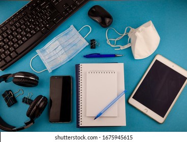 Medical Mask On The Desktop. Remote Work And Study. Telework, Freelance. Tablet, Phone, Notepad With Place For Text And Pen For Notes. Layout. Desktop, Workspace For Working At Home. Office Background