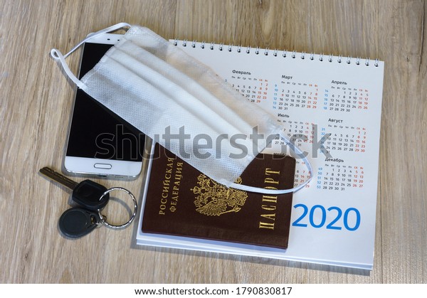 medical mask and
phone and passport on the table, white medical mask and calendar
for 2020, medical mask and
keys