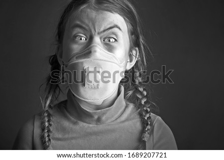 Medical mask, protection against coronavirus and other viruses. Little girl vampire on black white background