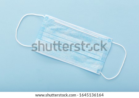 Medical mask, Medical protective mask on blue background. Disposable surgical face mask cover the mouth and nose. Healthcare and medical concept.
