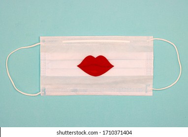 medical mask with a red kiss, lips in the center. the concept of restricting kissing and lip-painting for lovers due to quarantine.
