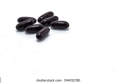 Medical and medicine concept. Black capsul on white background.
