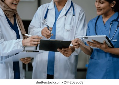 Medical, meeting and laptop for team in office in discussion, brainstorming and planning. Doctor, nurse and tablet, teamwork or workshop for data analytics. - Powered by Shutterstock