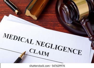 Medical Negligence Claim  And Gavel On A Table.