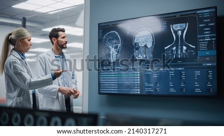 Medical Neuroscience Hospital Lab Meeting: Diverse Team of Neurosurgeon and Neurologist Analyze TV Screen Showing MRI Scan with Brain Images, Talk About Sick Patient Treatment Method, New Drugs Cure