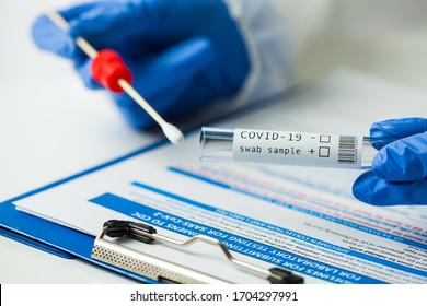 Medical NHS worker holding Coronavirus COVID-19 NP OP LFT swab sample test kit,nasal collection equipment submitting form,reverse transcription RT-PCR DNA molecular nucleic acid diagnostic procedure  - Shutterstock ID 1704297991