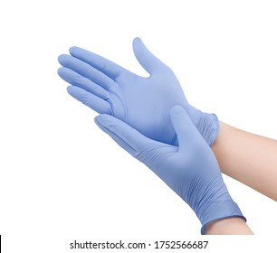 Medical nitrile gloves.Two blue surgical gloves isolated on white background with hands. Rubber glove manufacturing, human hand is wearing a latex glove. Doctor or nurse putting on protective gloves - Shutterstock ID 1752566687