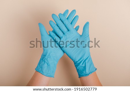 Medical nitrile gloves.Two blue surgical gloves on pastel background