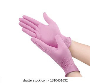 Medical nitrile gloves.Two pink surgical gloves isolated on white background with hands. Rubber glove manufacturing, human hand is wearing a latex glove. Doctor or nurse putting on protective gloves
