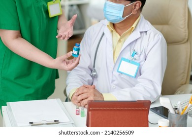 Medical Nurse And General Practitioner Discussing New Vaccine Against Coronavirus