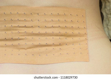 Medical Objects, Health Problems Concept. Closeup Of Heating Pad Plaster Bandage On Back