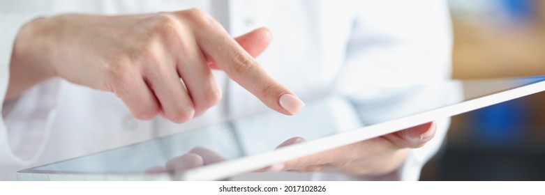 Medical officer doctor points his finger at tablet - Shutterstock ID 2017102826