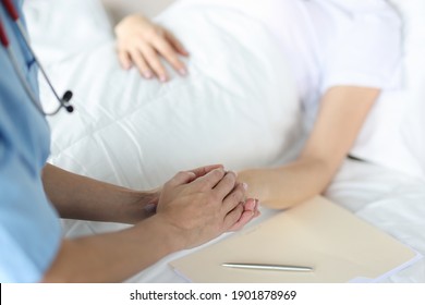 Medical Officer Holds Patient's Hand. Medical Care And Patient Care In Hospital Concept