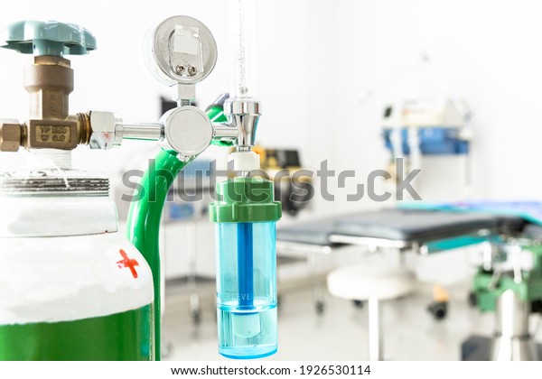 Medical oxygen flow meter shows low oxygen with\
patient bed in hospital, Equipment medical Oxygen tank and Cylinder\
for care a patient respiratory disease and emergency CPR at\
Hospital.