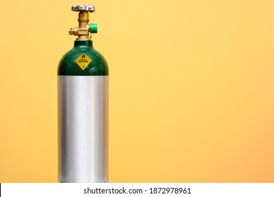 Medical Oxygen Tank Isolated On Yellow Background