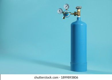 Medical Oxygen Tank On Light Blue Background. Space For Text