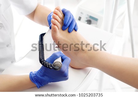 Medical pedicure. Podologist develops feet with a milling machine. Zdjęcia stock © 