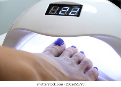 Medical Pedicure. Uv Lamp For Drying Nail Polish And Gel. Nail Polish Glows From Ultraviolet Light