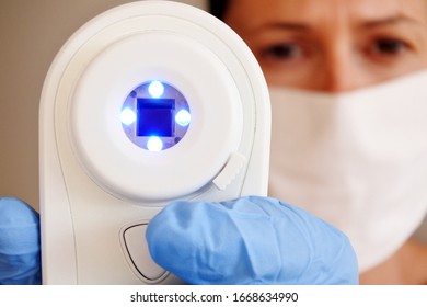 Medical person wearing medical face mask using no touch body thermometer on a sick person. (COVID-19) .Real people. Copy space - Powered by Shutterstock