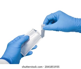 Medical Personnel Hand Tearing Envelope Of Covid-19 Antigen Rapid Test Kit On White Background,Coronavirus Infectious Protect Concept