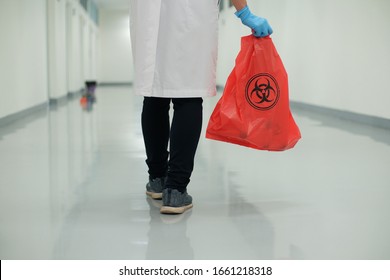 Medical Personnel Holding Infectious Waste Bag.