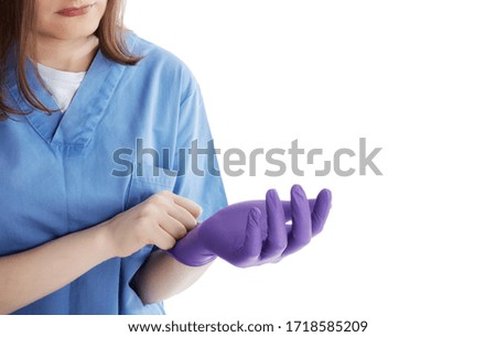 Medical personnel putting on latex gloves for protection against viruses. Isolated on white background.