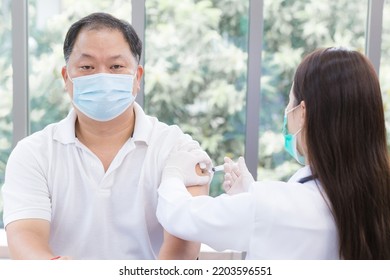 Medical Personnel Was Vaccinated For COVID-19 Or Infectious Diseases To The Asian Male People To Protect Health From Disease As Healthcare Protection In The Hospital.