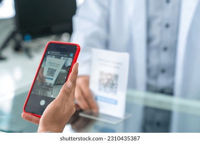 Medical pharmacy and contactless payment concept. Asian woman patient customer using mobile phone scan QR code on counter making online baking payment buying medicine and supplements in drugstore. - Powered by Shutterstock