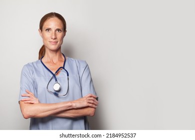 Medical Physician Doctor Standing With Crossed Arms On White Background. 