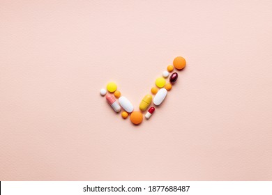 Medical Pills Check Mark Symbol Isolated On Pink Background. Medicine Approve Sign Concept. Outer Space. Above View.