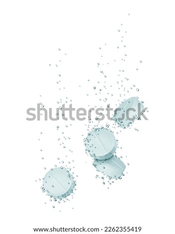Medical pills dissolves in water close-up isolated on a white background