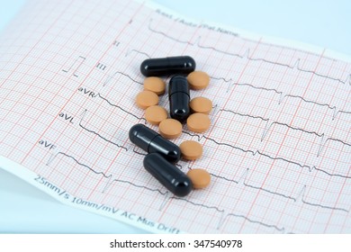 Medical Pills On A ECG. Pills On A ECG Strip. Hearth Disease And A Cure.