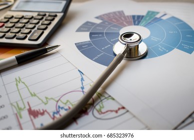 Medical Practice Financial Analysis Charts With Stethoscope And Calculator Concept