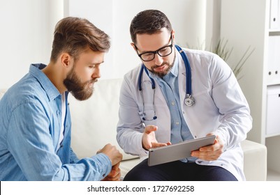 Medical practitioner in glasses showing test results to man and explaining diagnosis while sitting on couch in office of modern clinic
 - Powered by Shutterstock