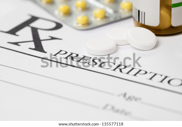 Medical\
prescription and several pills on\
table