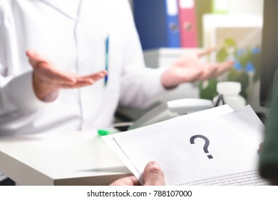 Medical Problem. Patient Reading Health Care Document With Question Mark. New Or Unknown Disease. Can't Find Or No Cure For Illness. Wrong Diagnosis. Clueless Doctor Spreading Hands.