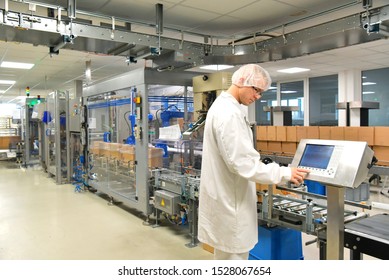 medical products manufacturing in a modern factory - worker operates modern industrial plant 