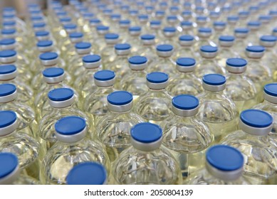 medical products manufacturing in a modern factory - glass bottles with medications on conveyor belt 