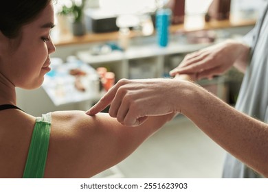 Medical professional administering vaccine injection on woman's arm for immunization prevention. Close-up of healthcare scene in a clinical setting - Powered by Shutterstock