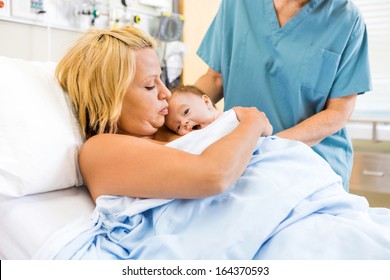 Medical Professional Assisting Mother With Skin To Skin Care In The Hospital