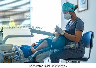 Medical professional dentist examines his patient's teeth with the use of special dental instruments. - Powered by Shutterstock