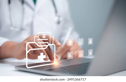 Medical professional efficiently managing document workflows. Utilizing a comprehensive document management system on laptop computer to search, organize, and handle files online document database. - Powered by Shutterstock