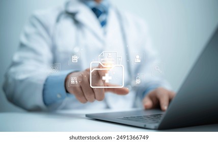 Medical professional efficiently managing document workflows. Utilizing a comprehensive document management system on laptop computer to search, organize, and handle files online document database. - Powered by Shutterstock