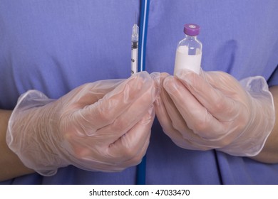 Medical professional holding medicine and syringe
