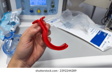 medical professional using airway equipment, mask, laryngoscope, and oral airway, to assist with patient intubation - Powered by Shutterstock