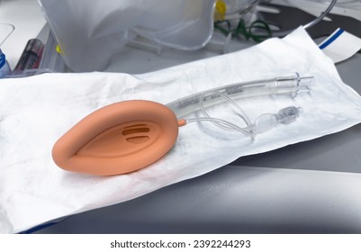 medical professional using airway equipment, mask, laryngoscope, and oral airway, to assist with patient intubation - Powered by Shutterstock